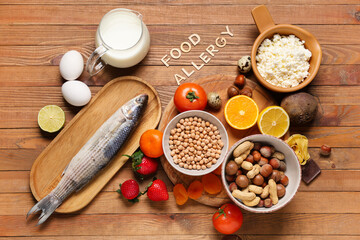 Different products with text FOOD ALLERGY on wooden background
