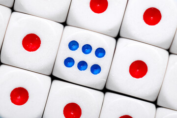 Dices with red and blue pips as background, closeup