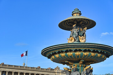 Fountain at the Place de la Concorde and french flag, Paris, France