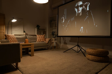 Interior of stylish living room with grey sofas, coffee table and modern projector screen