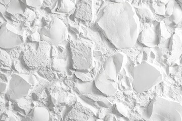 Close-up view of a textured white stone wall, showing irregular shapes and fragments