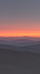 Fototapeta premium Serene Sunset Landscape Rolling Hills and Vibrant Sky at Dusk