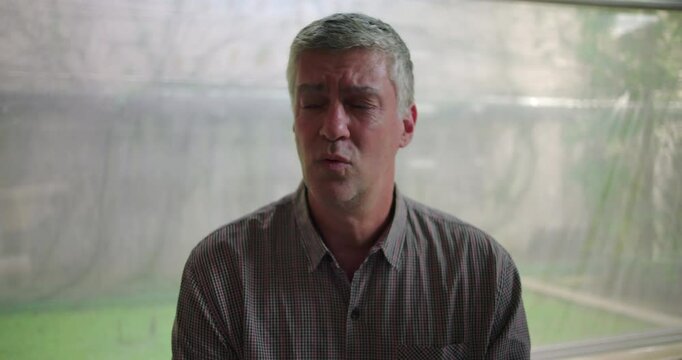 Middle aged man delivering heartfelt confession in therapy circle, emotional breakthrough shared with supportive group during powerful moment of vulnerability and truth