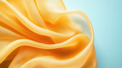 Obraz premium A gently flowing soft yellow fabric elegantly draped over a serene blue background, creating a tranquil and inviting visual effect with its smooth textures.