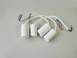 cylindrical capacitor with metal terminals isolated white background. used for single phase...