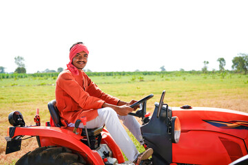 farmer sitting on tractor at agriculture field © Shivani
