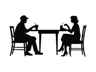 Silhouette of a couple enjoying drinks at a table
