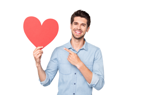 Portrait of charming man with positive emotions expression hold hand red big paper card heart present his gift for 14-february to girlfriend wear casual style clothes isolated grey color background