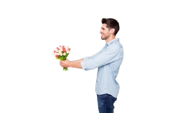 Profile side photo of positive cheerful man lover have fun give tulips bouquet to his girlfriend on 8-march 14-february date copyspace have fun wear stylish clothes isolated over grey color background