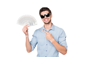 Photo of cheerful attractive handsome man pointing at money he earned out of sold project smiling toothily isolated over grey color background