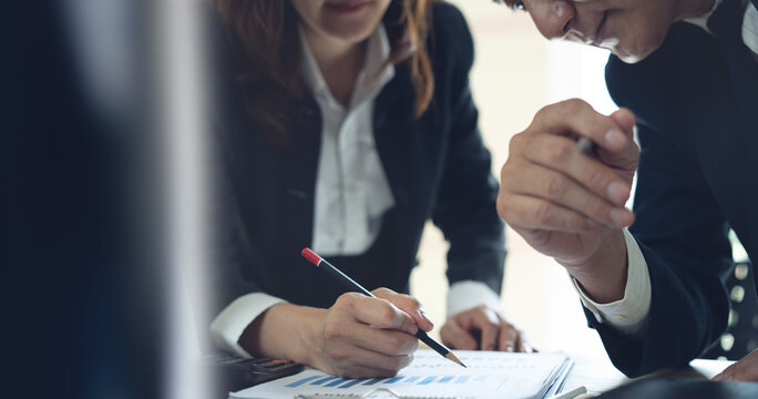 Business team have a discussion on financial report, business analyzing marketing data at office. Bookkeeping, document for financial planning, accounting and business budget management, close up - Powered by Adobe