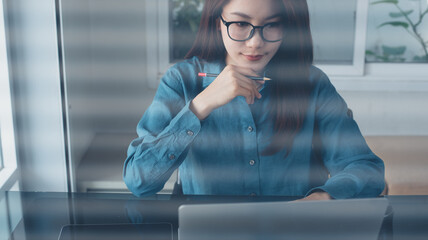 Young smart business woman working on laptop computer at office. Confident businesswoman using laptop for online meeting, looking at computer screen, webinar, video conference, remote work