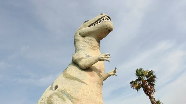 Large dinosaur sculpture, famous roadside tourist attraction along interstate highway 10 in Cabazon, California. Tyrannosaurus Rex. Shot in 2014.