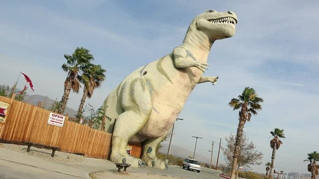 Large dinosaur sculpture, famous roadside tourist attraction along interstate highway 10 in Cabazon, California. Tyrannosaurus Rex. Shot in 2014.