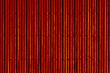 close up of red mat made of bamboo sticks
