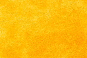 close up of canvas stained with yellow and orange paints