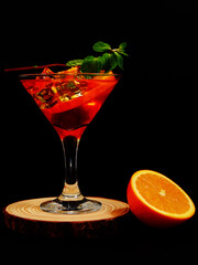 fresh mojito cocktail glass closeup shot on black background 