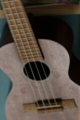 Fototapeta premium A detailed closeup shot of a beautifully crafted ukulele gently resting on a vibrant, colorful surface that captivates the view