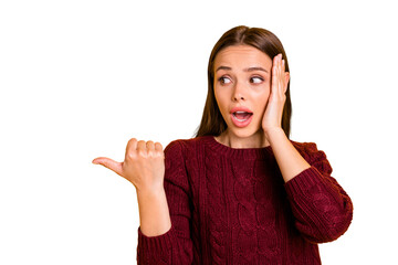 Close up photo of impressed lady pointing ads at copy space wearing marsala jumper isolated over yellow background