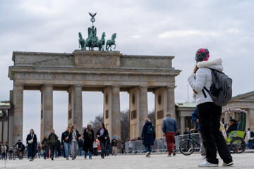 Mujer turista paseando por la Pariser Platz en Berlín, Alemania, y descubriendo la Puerta de Brandeburgo © Javier