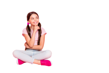 Portrait of interested minded kid look touch chin with fingers sitting wear white t-shirt isolated over pink background