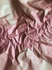 Beige and rose crumpled paper close up. Texture of vintage cardboard. Crinky paper background. Copy space for your text