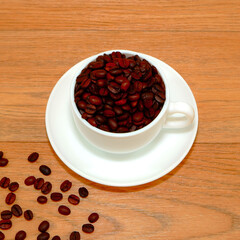 coffee mug with coffee beans closeup view on wooden background 