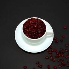 coffee beans with coffee cup closeup view on black background , coffee concept photography 