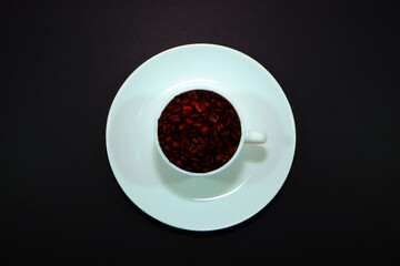coffee beans with coffee cup closeup view on black background , coffee concept photography 