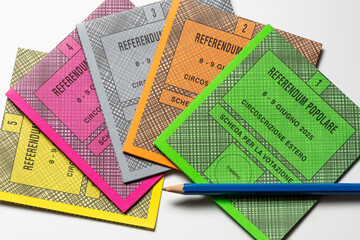 Colored ballot slips for the five questions of 2025 Italian popular referendum, officially Abrogative Referendums in Italy, with pencil on a white background