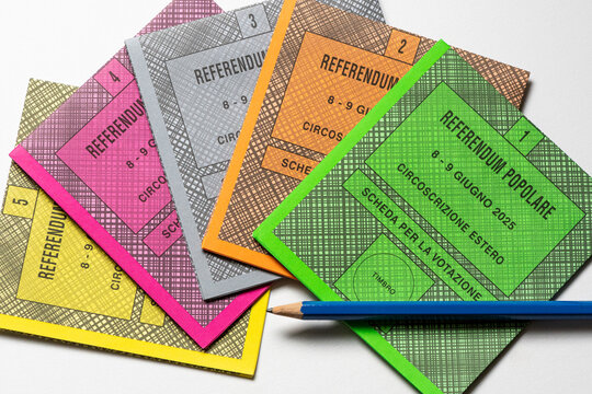 Colored ballot slips for the five questions of 2025 Italian popular referendum, officially Abrogative Referendums in Italy, with pencil on a white background