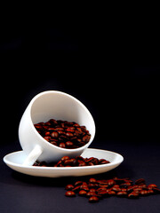 coffee beans on coffee cup closeup view on black background, coffee concept photography 