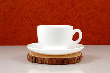 ceramic coffee cup on wooden plate closeup view 