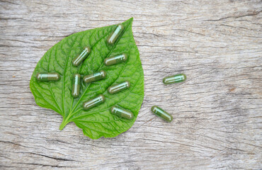 Herbal capsules from green herbal on leaf for healthy eating in daily life