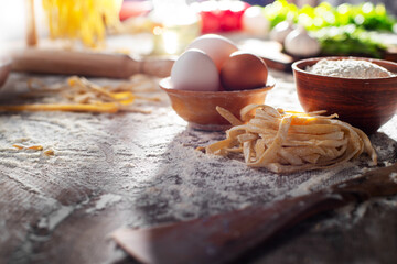 Portion of homemade noodles on floured kitchen table cooking background