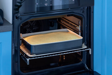 Baking a cake in the oven in the kitchen