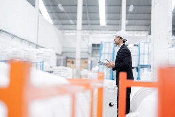 In response to increased demand, the male engineer led an expansion of the industrial plant,...