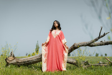 Women posing in pink dress in mustard fields, shoot for kaar kash