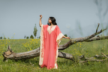 Women posing in pink dress in mustard fields, shoot for kaar kash