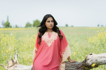 Women posing in pink dress in mustard fields, shoot for kaar kash