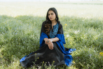 Women wearing Blue Kashmiri dress posing out in the nature