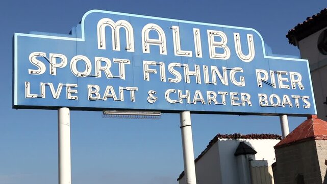 Iconic sign marking the Malibu Pier, along the Pacific Coast Highway in southern California. "Malibu sport fishing pier, live bait & charter boats".
