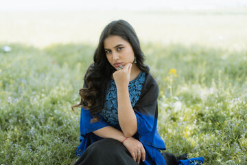 Women wearing Blue Kashmiri dress posing out in the nature