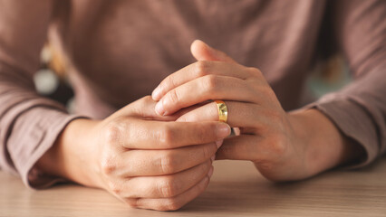 Woman takes off an wedding ring	