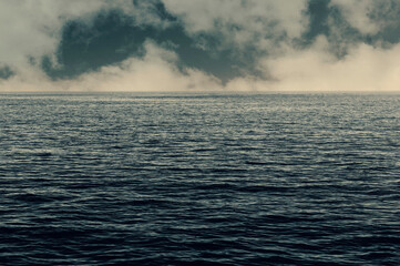 Calm weather on sea or ocean with clouds. Stormy clouds over the ocean.