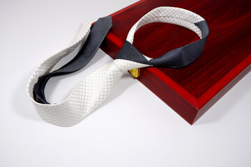 slim fit necktie on wooden board closeup view with white background 