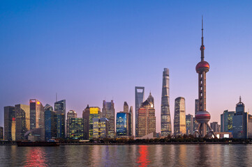 Morning sun rise of Shanghai city modern skyscraper cityscape in blue sky autumn season behind...