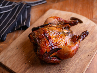 Whole Grilled Chicken on Wooden Table.