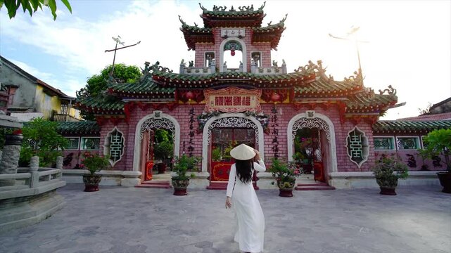 Tourist walking at Fukian Assembly Hall in the Hoi An ancient town, Vietnam.
