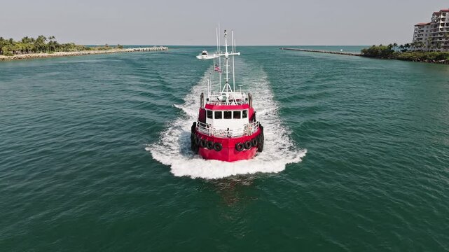 Tugboat sea transportation. Boat tug at sea. Aerial footage of tow-boat transportation. Tugboat sailing at sea top view. Motor boat. Boating and tugging. Tow boat in Miami canal